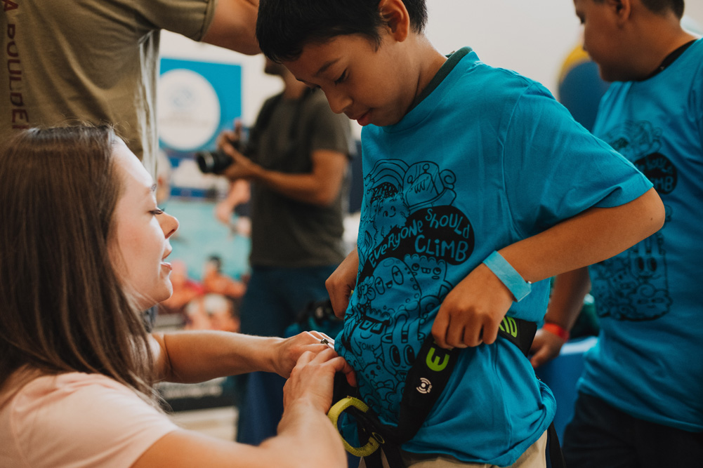 LA Variety Boys and Girls Club member gets fitted for a climbing harness.